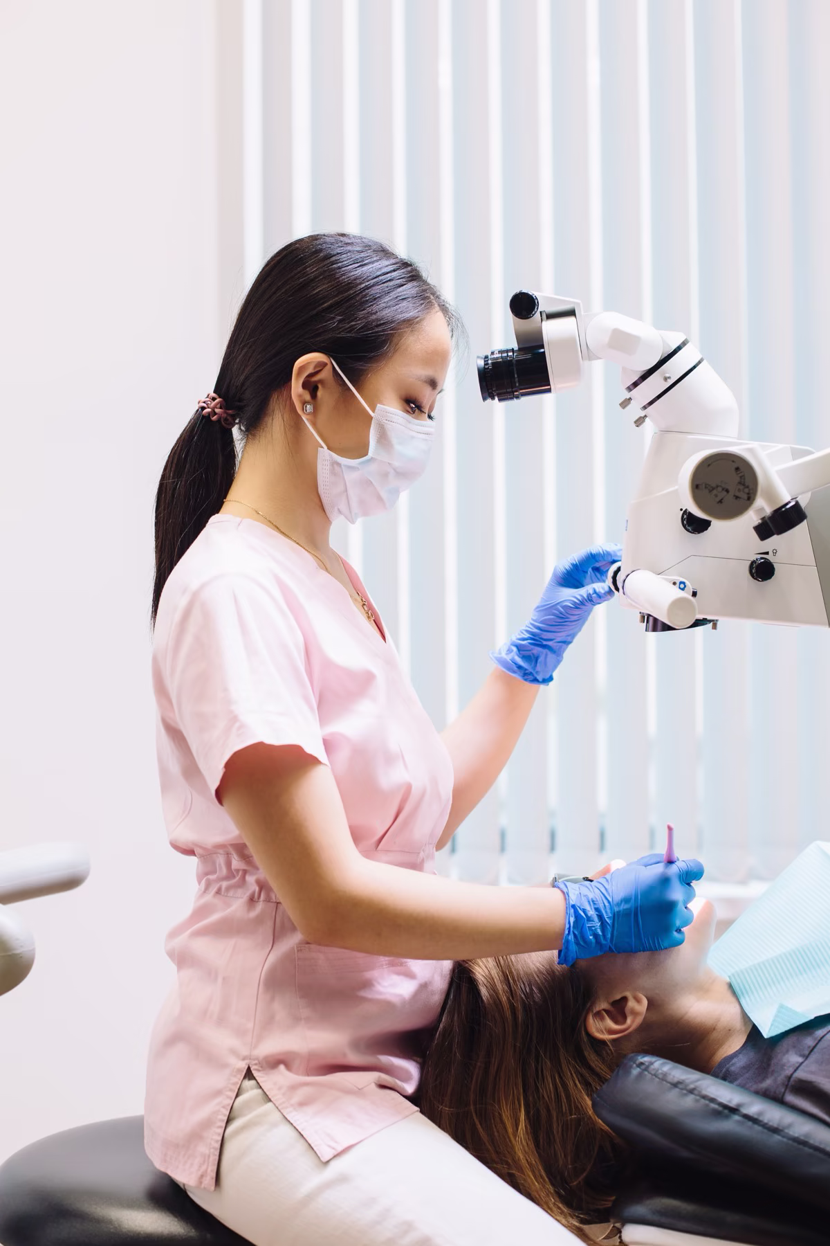 Endodontist performing microscope-guided root canal treatment
